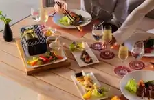 Beach club at resort in Maldives, with palm trees, white sand, and crystal-clear blue waters.